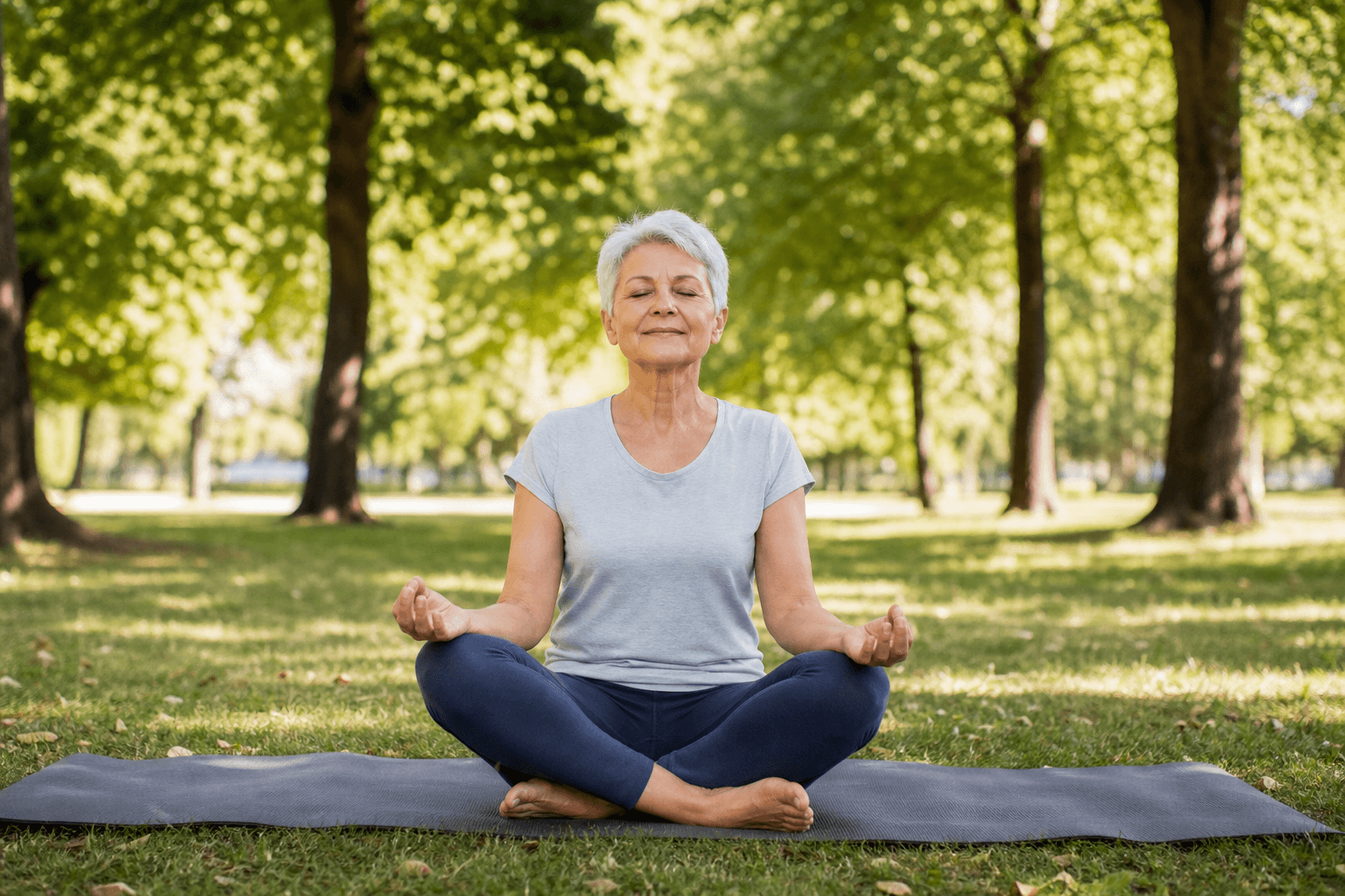 Woman meditating outdoors in a park